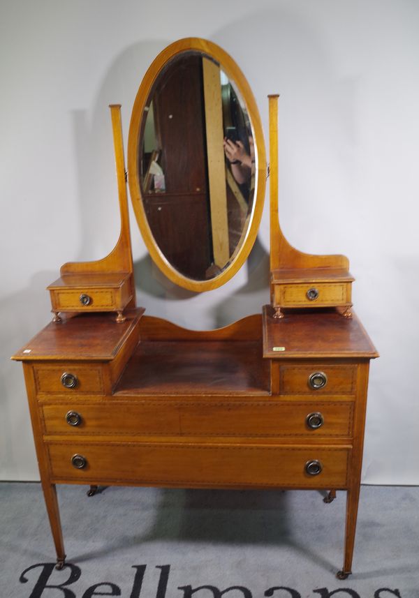 An Edwardian mahogany and inlaid dressing table with oval mirror, 107cm wide x 83cm high.