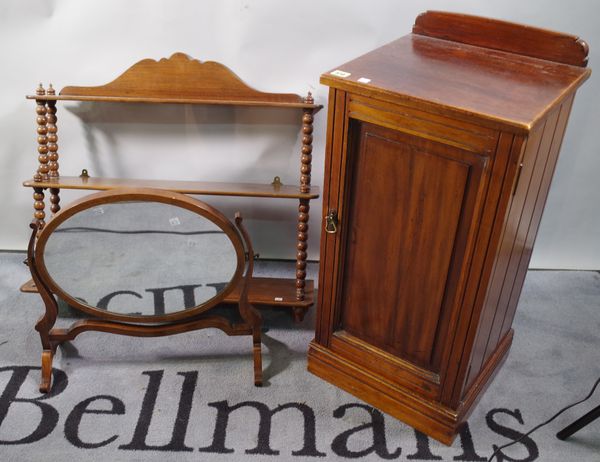 An Edwardian mahogany pot cupboard, 38cm wide, a mahogany three tier wall shelf, 76cm wide, and an oval dressing table mirror, 50cm wide.