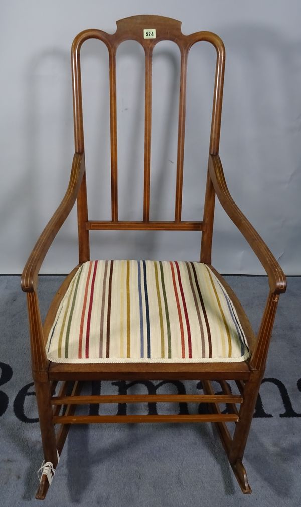 An Edwardian mahogany and inlaid rocking chair, 52cm wide x 104cm high.