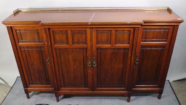 An Edwardian walnut breakfront bookcase with four panelled doors, 189cm wide.