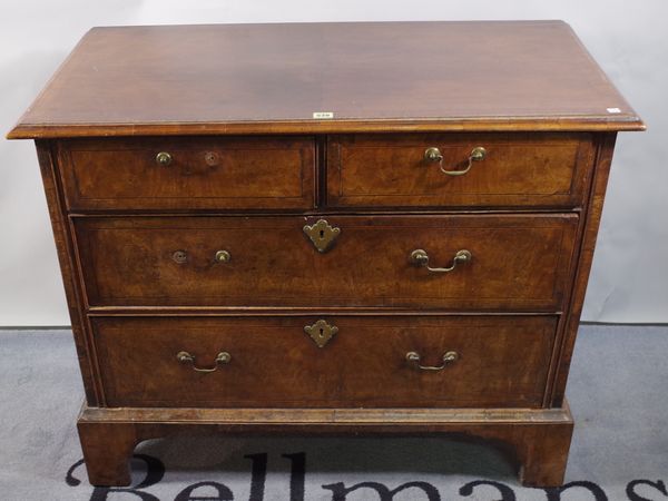 A late 18th century mahogany and walnut chest of two short and two long drawers on bracket feet, 103cm wide x 83cm high.