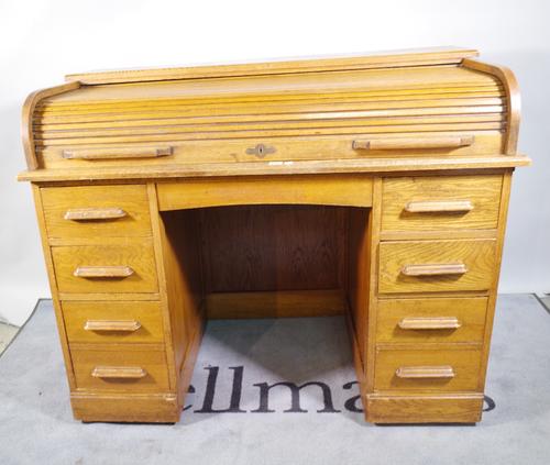A 20th century oak roll top desk with eight drawers about the knee, 121cm wide x 91cm high.