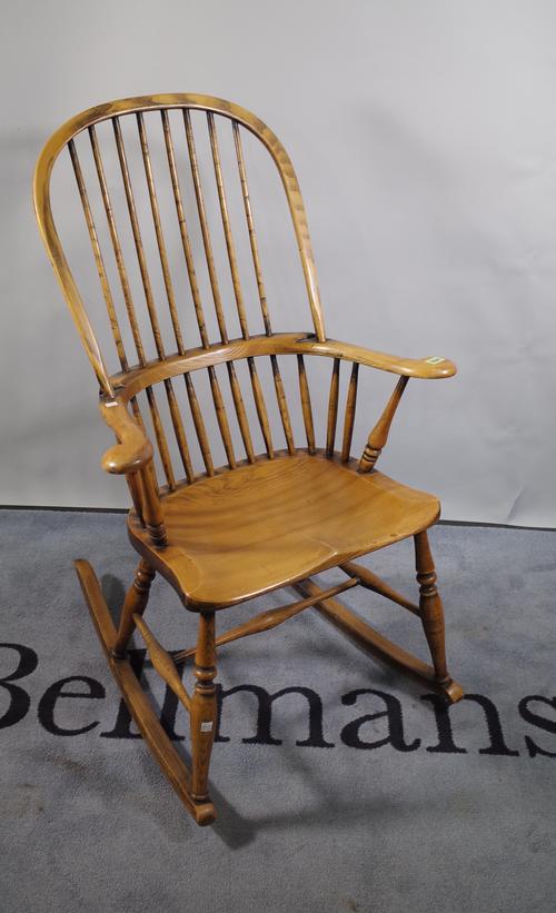 A 20th century ash and elm stick back rocking open armchair, 64cm wide x 107cm high.