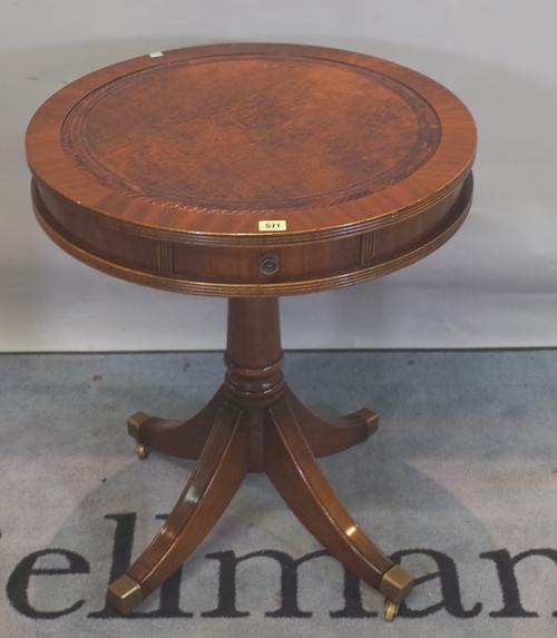 A Regency style mahogany single drawer writing table with tooled green leather top, 68cm wide x 77cm high, and a Regency style mahogany drum table wit