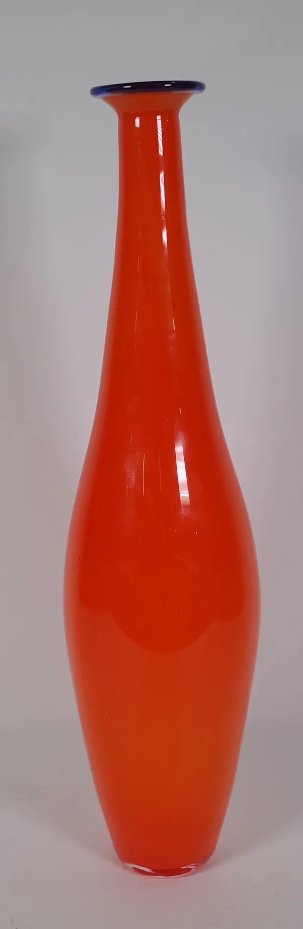 A continental orange glass vase, possibly Austrian, 20th century, of skittle form with blue glass rim, 40cm. high.