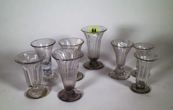 A group of eight jelly glasses, 18th/ early 19th century, each with a bell bowl, some with wrythen moulding, 9cm. to 12cm., (8). CAB