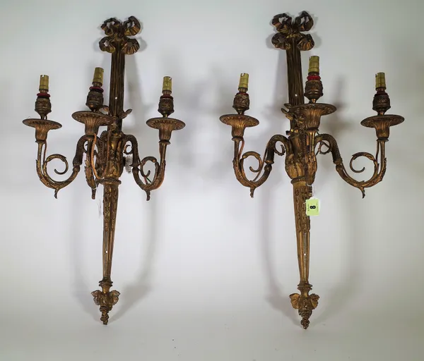 A pair of  French gilt bronze three branch wall appliques, late 19th century, with bow surmount, ribbon backplate issuing three foliate scroll branche