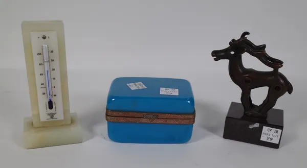 An onyx desk thermometer, 12cm high, a blue glass rectangular casket with gilt metal mounts, 9cm wide and an abstract bronze reindeer, indistinctly si