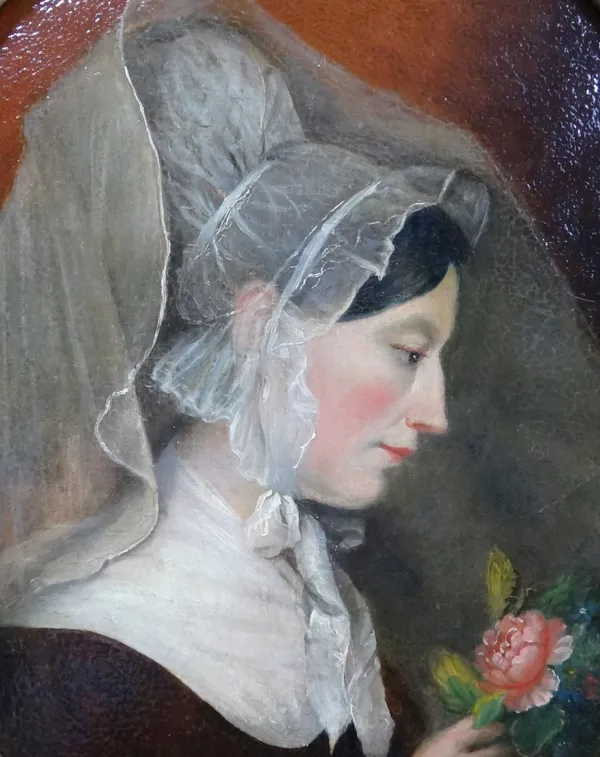 English School (19th century), Profile portrait of a woman in lace cap holding a rose, oil on canvas, oval, 38cm x 30cm.