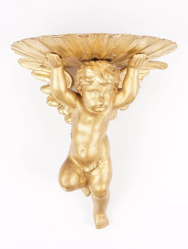 A late 19th century giltwood wall bracket, carved as an angel supporting a clam shell, 32cm high.