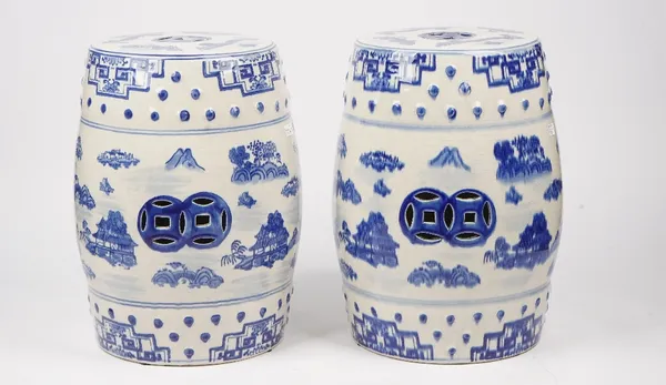 A pair of modern Chinese style blue and white garden seats, each decorated with landscape scenes, against a pierced barrel form ground, 45cm high. (2)