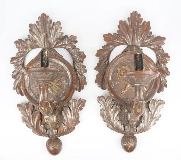 A pair of 19th century gilt/silvered wooden wall sconces, each with carved circular back plate with acanthus border and single arm sconce, 63cm high.