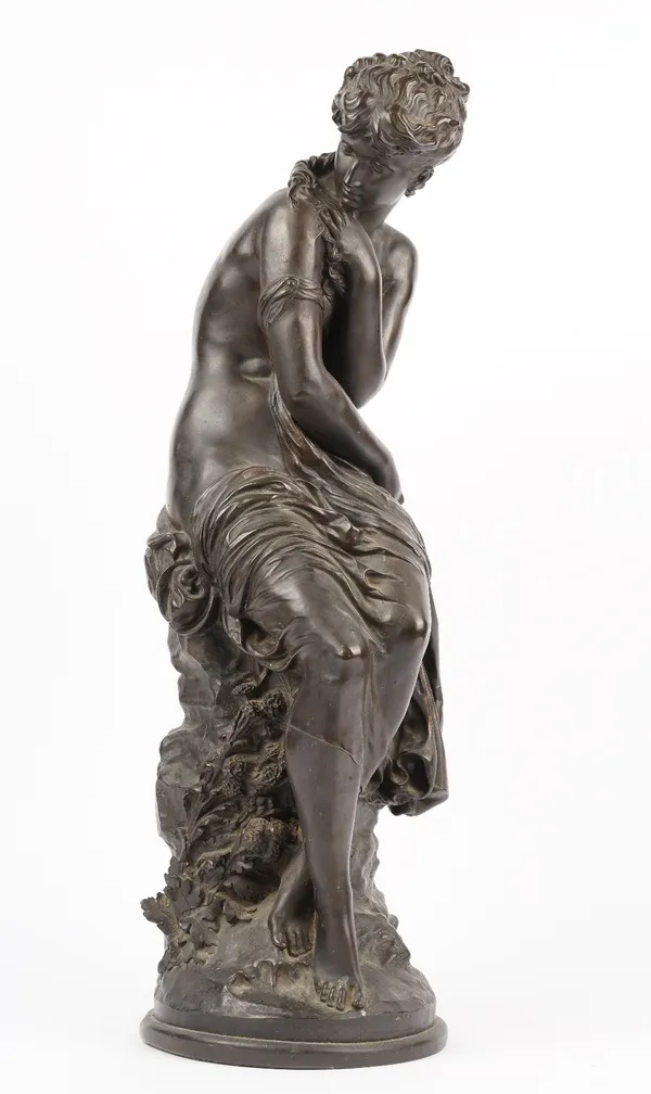 After Moreau, a modern composite bronze female figure, partially clothed and seated on a rock, 64cm high.