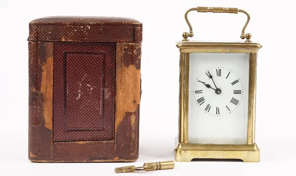 An early 20th century brass cased carriage clock with enamel dial, visible escapement and single train movement, 11.5cm high, (case and key).