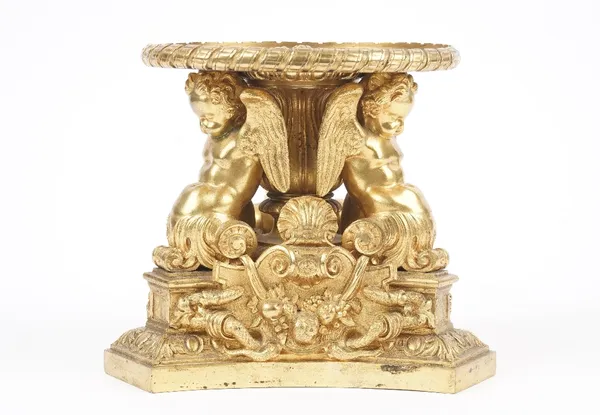 A late 19th century gilt bronze tazza base (lacking top), cast with fruit, swags, shells and three winged cherubs supporting a circular plate, 17.5cm