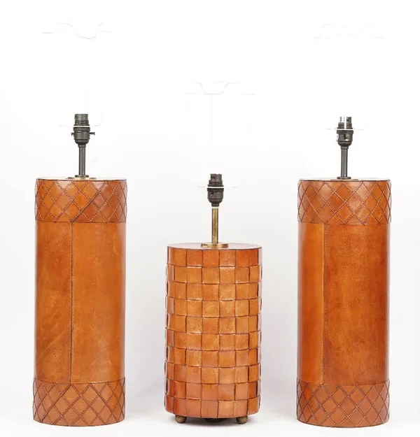 A pair of modern leather bound table lamps with silk shades and a smaller leather bound table lamp with a silk shade, 82cm high overall. (3)