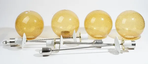 A set of four 1970s Swedish style lanterns, modern, each chrome stem supporting an amber glass shade of spherical form, 90cm high. (4)