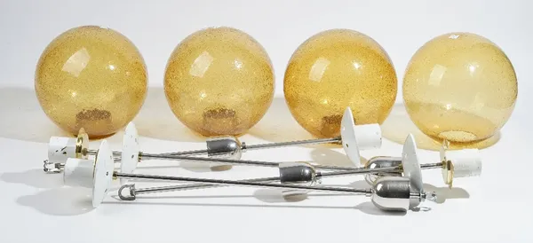 A set of four 1970s Swedish style lanterns, modern, each chrome stem supporting an amber glass shade of spherical form, 90cm high. (4)