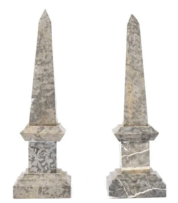 A pair of modern grey marble obelisks, of stepped square form, (a.f.), 70cm high. (2)