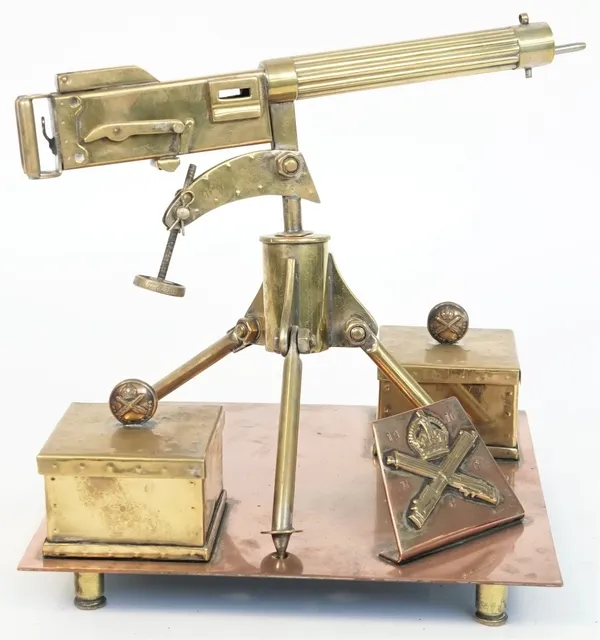 A brass model of a WWI Vickers machine gun, 20th century, with two ammunition boxes and covers on a square copper base and four brass "Shell case" fee