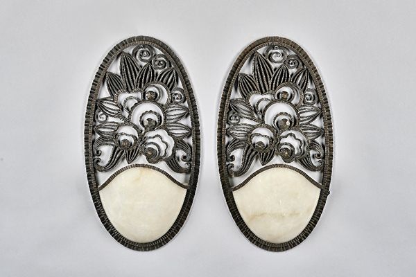 Raymond Subes attributed, a pair of French wrought iron and marble mounted wall lights, each backplate of oval form with foliate pierced decoration wi