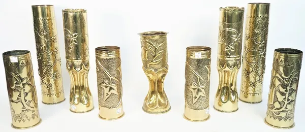 A pair of WWI brass trench art shell cases formed as vases, each dated 1916 and embossed with flora, 34.5cm high, a smaller similar brass shell case w