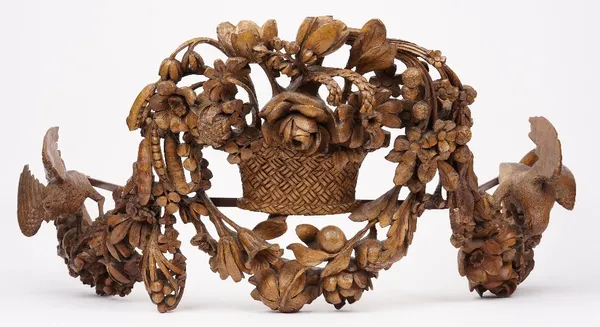 An English limewood carving, 19th century, in the manner of Grinling Gibbons, detailed with fauna and flora, adapted for use as a bed coronet, 86cm wi