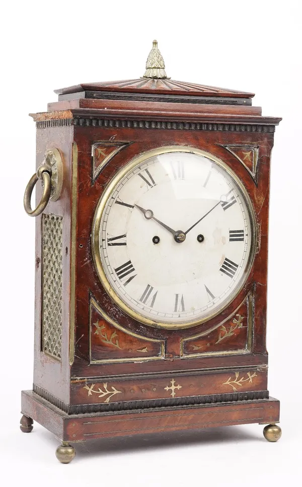 An early 19th century mahogany and brass inlaid bracket clock, with eight inch painted tin dial and twin brass ring handles, enclosing a two train mov