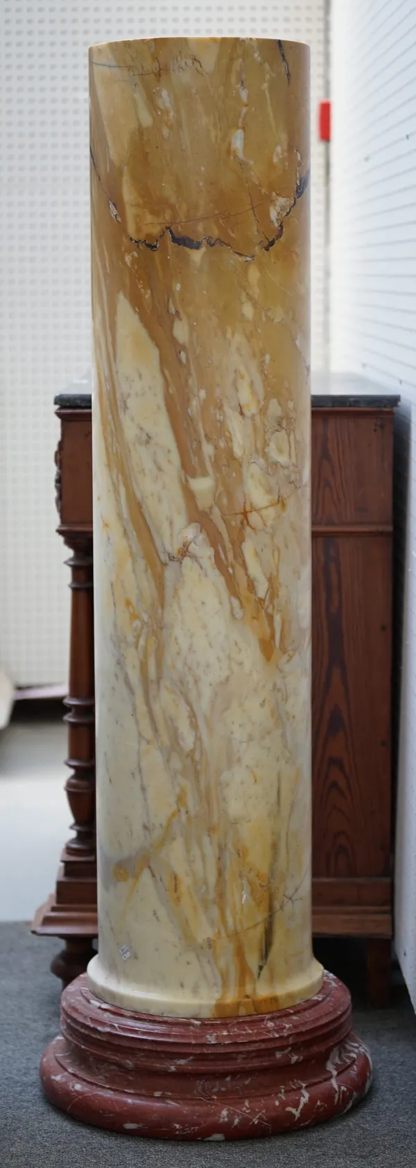 A pair of large marble pedestal columns, yellow veined on rouge marble circular bases, 133cm high overall. (2)