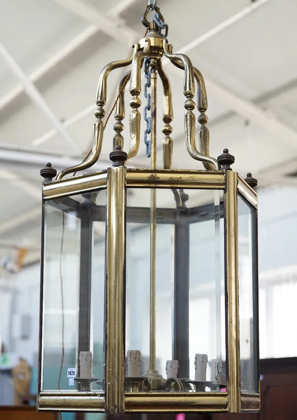 A Victorian style gilt metal hall lantern of hexagonal form, with bevelled glass panels and an internal five light fitment, 110cm high.