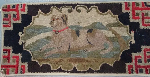 A Victorian hooked rag rug wall hanging, the black field with a scalloped cartouche of a spaniel lying down, Chinese fret spandrels, 60cm x 123cm.