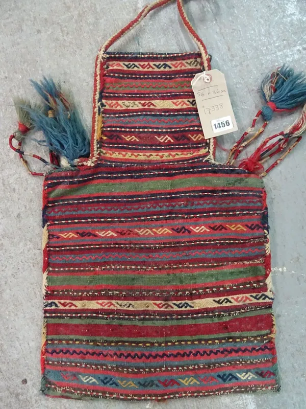 A South Persian bag, the multi coloured narrow bands with some embroidered areas, tassels and carrying handle, 56cm x 36cm.