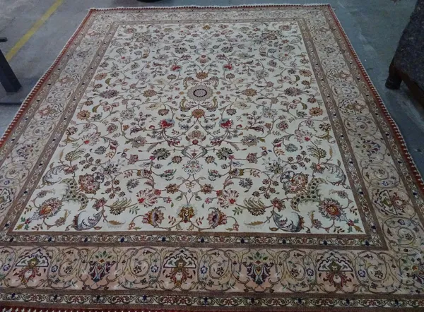 A part silk Ghom carpet, Persian, the ivory field with a minor central medallion, corner designs, all with floral sprays; a pale pink palmette and lil