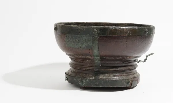 An 18th century metal mounted hardwood turned footed bowl, 36cm diameter x 22cm high.