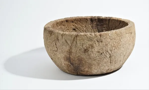 A circular dug out burr wood bowl, probably 19th century, 44cm diameter x 23cm high.