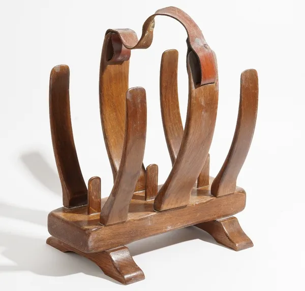 20th century desgin, a teak fish skeleton magazine rack, with leather strap handle, 40cm wide x 42cm high.