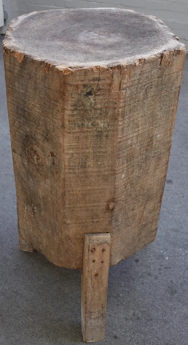 A large primitive made trunk-form chopping block, on three square supports, 50cm diamter x 89cm high.