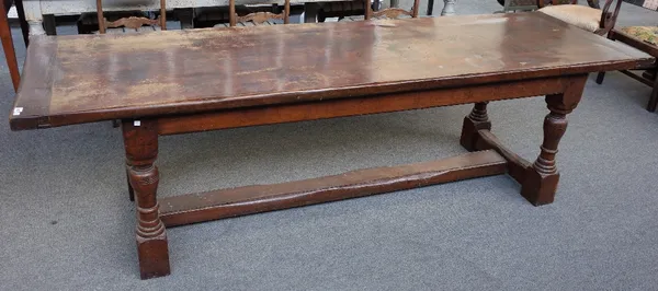 A 17th century style oak refectory table, the cleated plank top on baluster turned supports, 259cm long x 81cm wide.