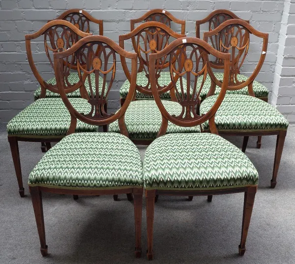 A set of eight late 19th century marquetry inlaid mahogany shield back dining chairs, on tapering square supports, 48cm wide x 91cm high.