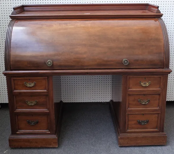 A Victorian mahogany roll top desk, with fitted interior, over six pedestal drawers, 138cm wide x 120cm high.