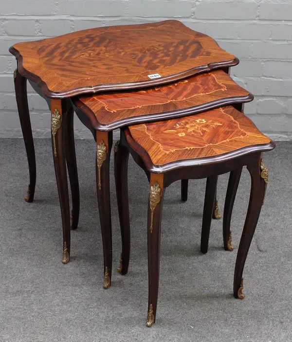 A nest of three gilt metal mounted parquetry inlaid mahogany occasional tables, on cabriole supports, the largest 63cm wide x 57cm high.