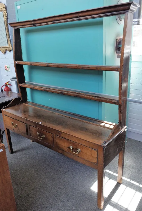 An 18th century oak dresser, the open two tier plate rack over three drawers, on block supports, 167cm wide x 180cm high.