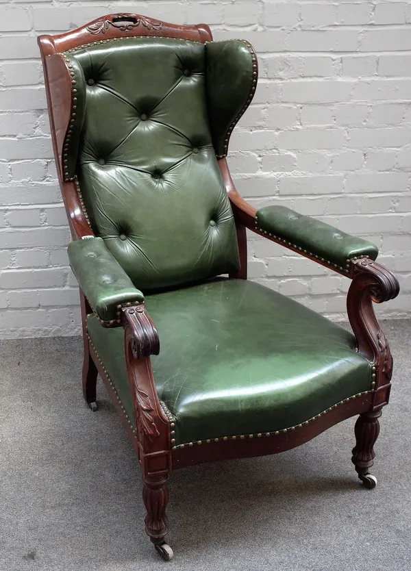 A Victorian mahogany framed green leather detachable wingback open armchair, on reeded baluster supports, 72cm wide x 113cm high.