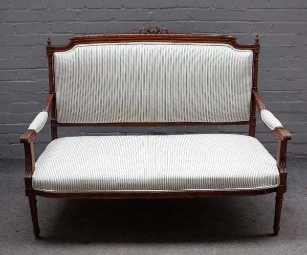 A Louis XVI style stained beech openarm sofa, on tapering fluted supports, 129cm wide x 101cm high.