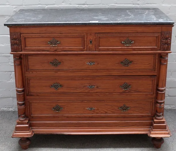 A late 19th century French marble top pitch pine commode, with two short over three long drawers, flanked by columns, 102cm wide x 90cm high.