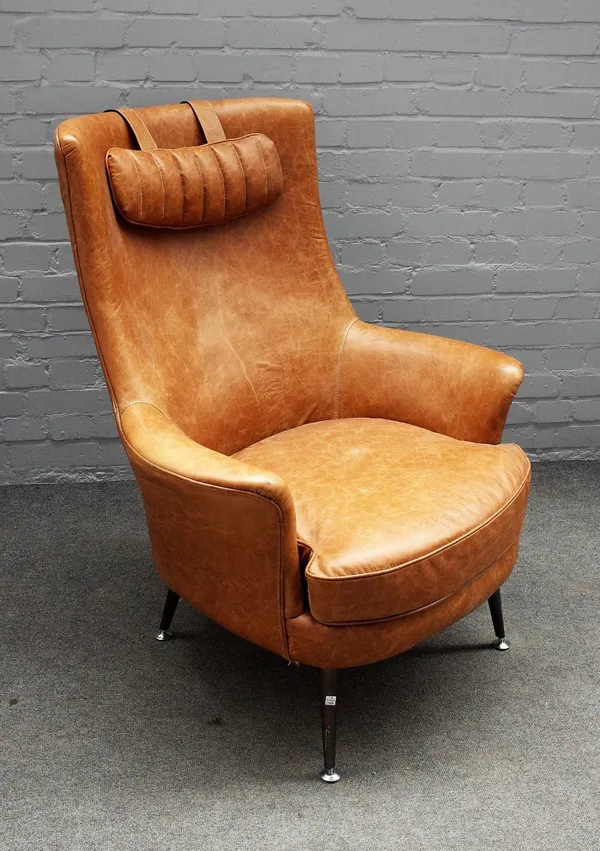 A retro design 1950s style tan leather armchair, on tubular metal supports, 90cm wide x 106cm high.