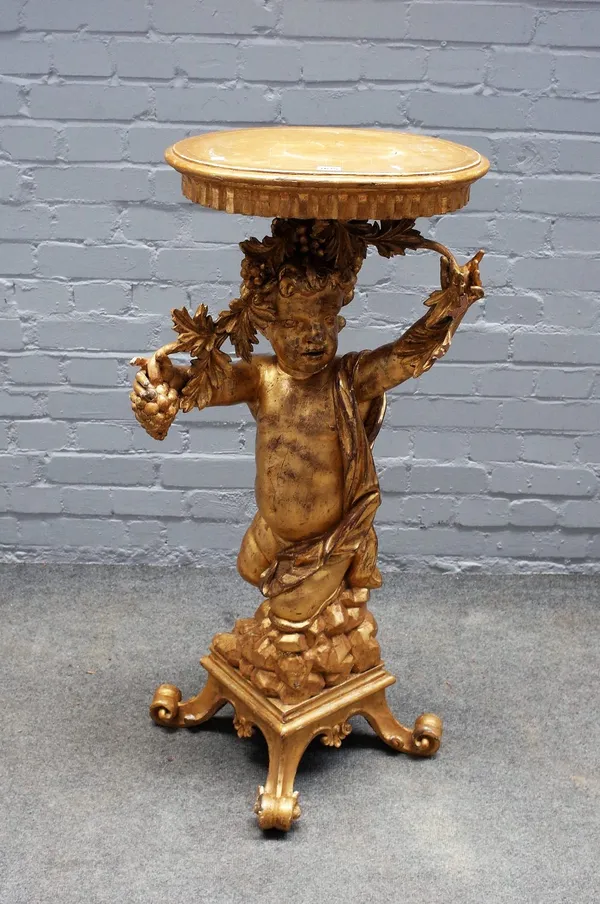 A 19th century giltwood jardiniere stand, the column carved as a young Bacchus on four scroll supports, 104cm high.