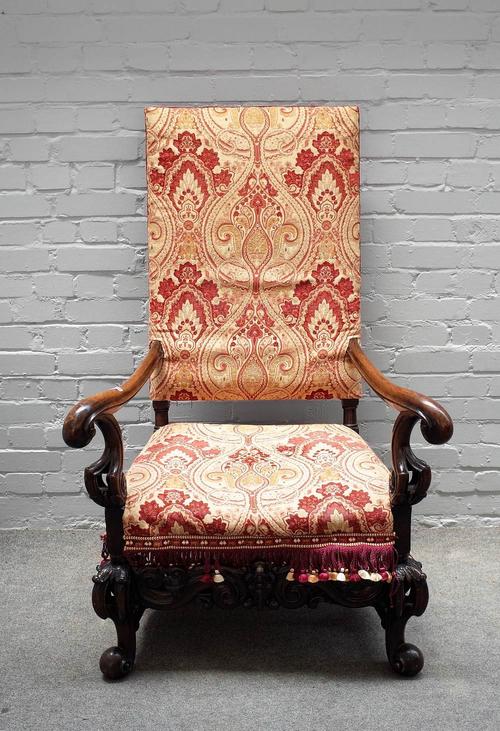 A 17th century Dutch style walnut framed square back open armchair, with carved frieze on scroll supports, 85cm wide x 129cm high.