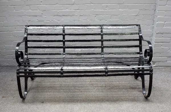 A 19th century black painted strap iron garden bench, 153cm wide x 78cm high.