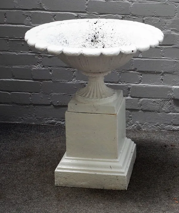 A white painted cast iron urn, on stepped square stand, 60cm diameter x 78cm high.